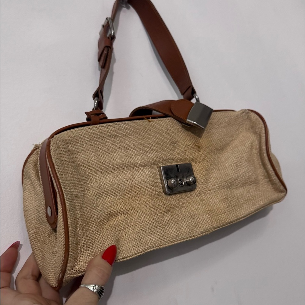 SoHo boutique: Woven canvas hand held purse with leather details.